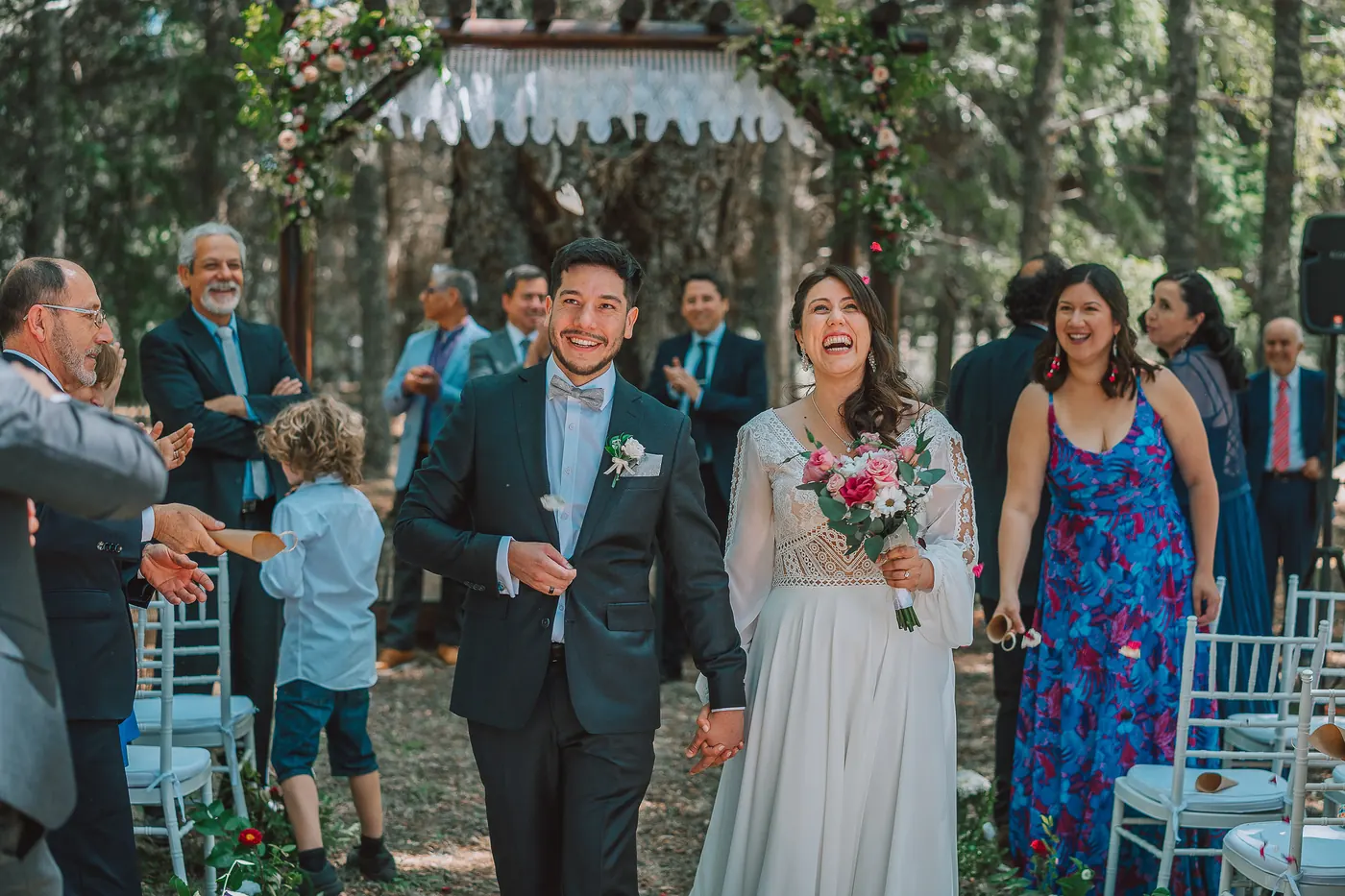 The couple walking back down the aisle among their guests