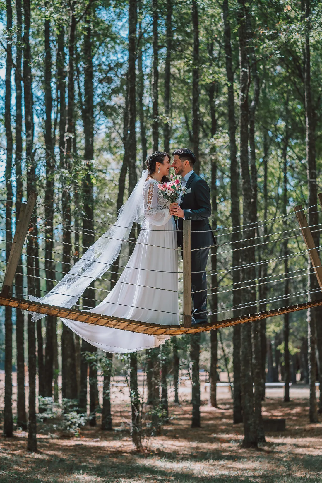 A couple on a rope bridge in a pine forest